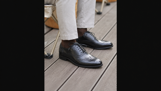 MORRIS ORIS black brogue formal shoes worn on a wooden deck